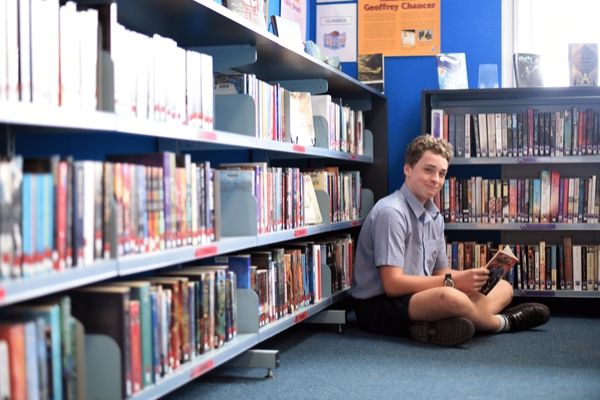 St Patrick's College Sutherland - student reading book in library