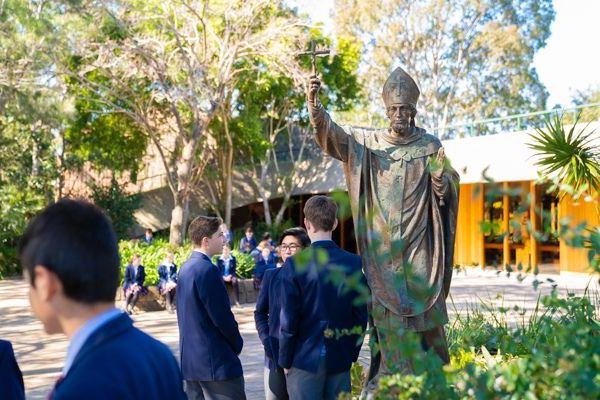 St Patrick's College Sutherland - statue of St Patrick in the courtyard with students